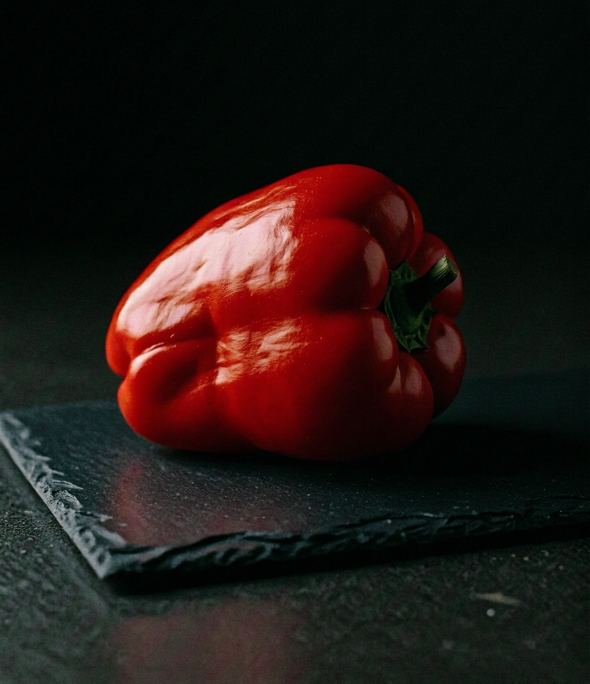 A textured Spanish red pepper on slate